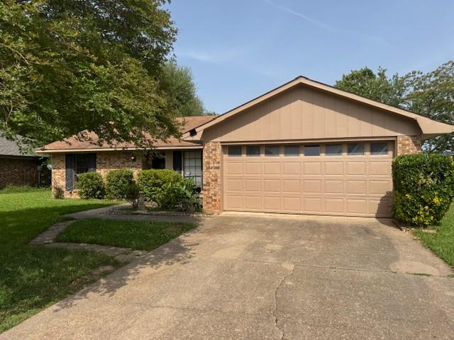 4931 General Rusk Dr, Bossier City, LA 71112 - ranch-style house featuring a garage, concrete driveway, a front yard, and brick siding