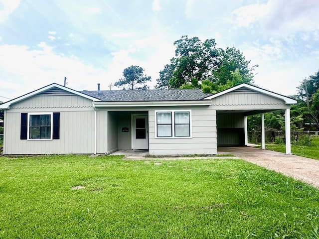 view of front of house with a carport, driveway, and a shingled roof