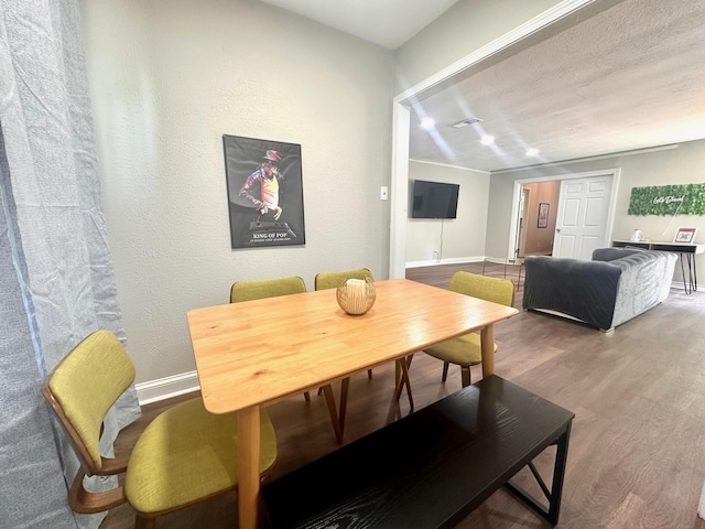 dining area featuring wood finished floors and baseboards