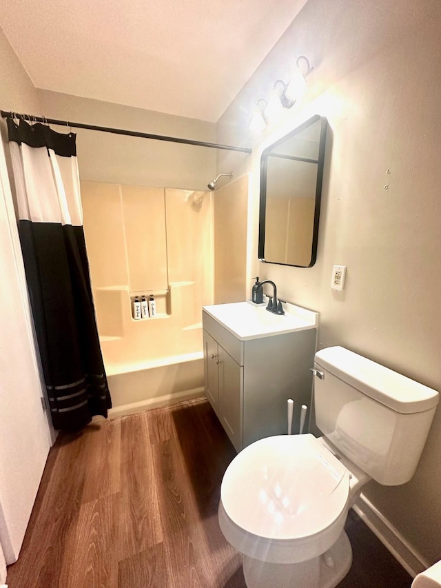 bathroom featuring wood finished floors, shower / bath combo, vanity, and toilet