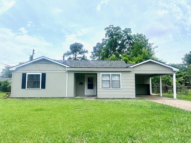 single story home with an attached carport, a front lawn, driveway, and a shingled roof
