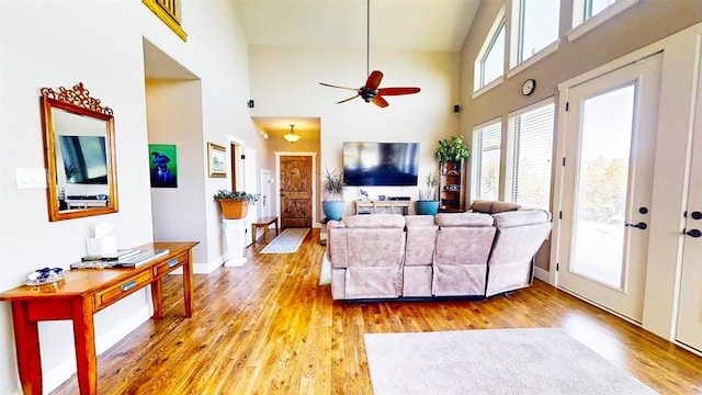 2807 Wind Point Ct, Tolar, TX 76476 - living area featuring a towering ceiling, light wood-type flooring, a ceiling fan, and baseboards