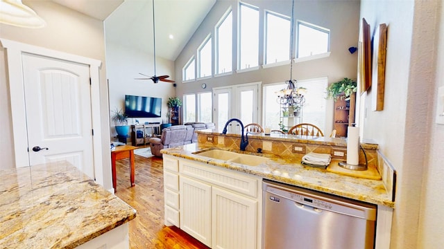 2807 Wind Point Ct, Tolar, TX 76476 - kitchen with dishwasher, a sink, light wood-type flooring, light stone counters, and a towering ceiling