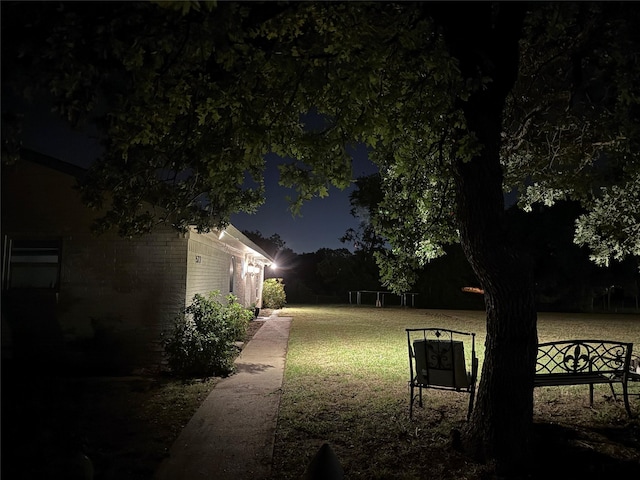 522 W 7th St, Weatherford, TX 76086 - yard at twilight with a lawn