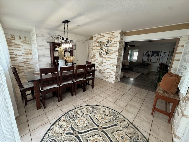 522 W 7th St, Weatherford, TX 76086 - dining area with light tile patterned floors, a chandelier, and a textured ceiling