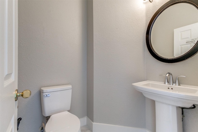 318 Mesquite Ct, Murphy, TX 75094 - half bathroom with toilet and a sink