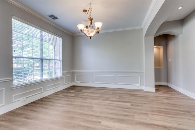 318 Mesquite Ct, Murphy, TX 75094 - unfurnished room with a chandelier, arched walkways, ornamental molding, light wood-style flooring, and a wainscoted wall