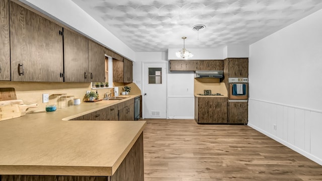 100 Oakhurst Dr, Hurst, TX 76053 - kitchen with wall oven, extractor fan, dishwasher, a chandelier, and light countertops