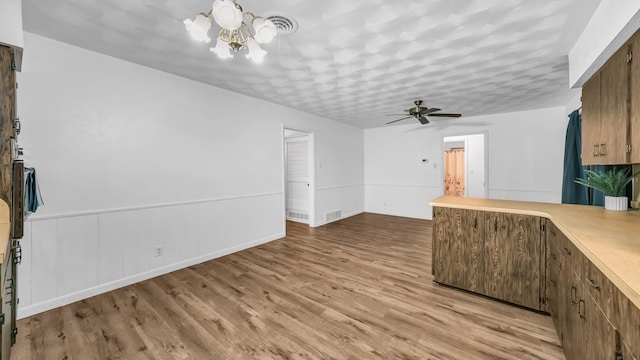100 Oakhurst Dr, Hurst, TX 76053 - unfurnished living room with light wood finished floors, a ceiling fan, and a chandelier
