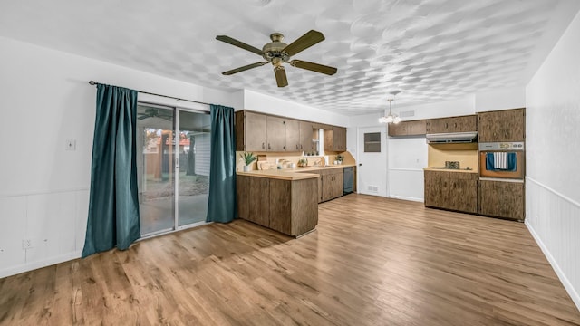 100 Oakhurst Dr, Hurst, TX 76053 - kitchen with oven, a peninsula, ceiling fan, light countertops, and a chandelier