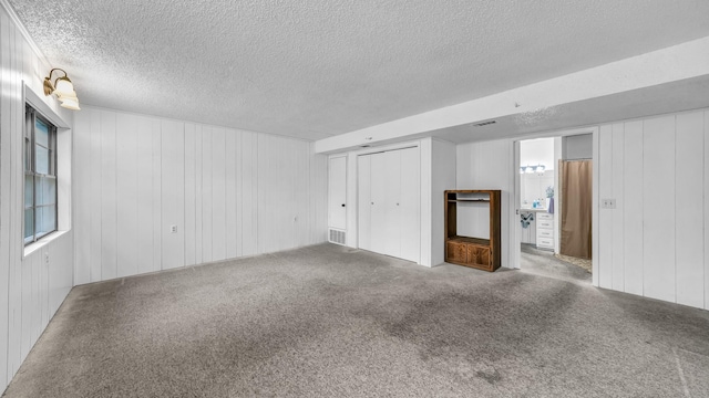 100 Oakhurst Dr, Hurst, TX 76053 - unfurnished living room with a textured ceiling and carpet