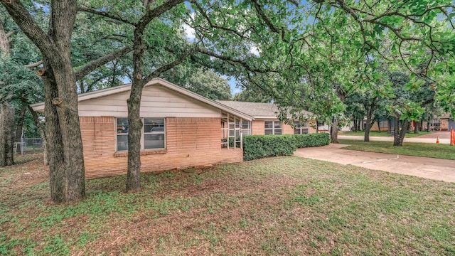 100 Oakhurst Dr, Hurst, TX 76053 - view of side of home featuring a lawn and brick siding
