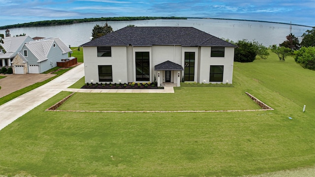 733 El Barco, Corsicana, TX 75109 - view of front of property with concrete driveway, stucco siding, a water view, a shingled roof, and a front yard