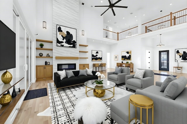 733 El Barco, Corsicana, TX 75109 - living room with light wood-style flooring, a ceiling fan, a fireplace, a high ceiling, and recessed lighting