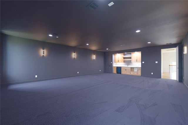 733 El Barco, Corsicana, TX 75109 - unfurnished living room featuring baseboards, carpet flooring, recessed lighting, and beverage cooler