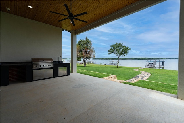 733 El Barco, Corsicana, TX 75109 - view of patio with an outdoor kitchen, area for grilling, a water view, a ceiling fan, and a sink