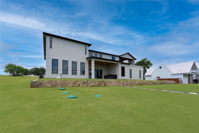 733 El Barco, Corsicana, TX 75109 - back of house featuring ceiling fan, a lawn, and stucco siding