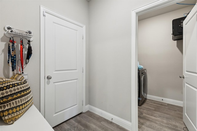 5909 Horsetail Dr, Mckinney, TX 75071 - laundry room with wood finished floors, washer / clothes dryer, and baseboards