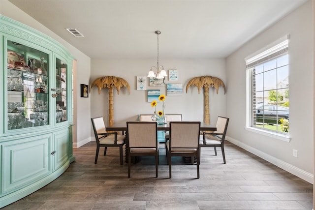 5909 Horsetail Dr, Mckinney, TX 75071 - dining room with a chandelier, wood finished floors, and baseboards