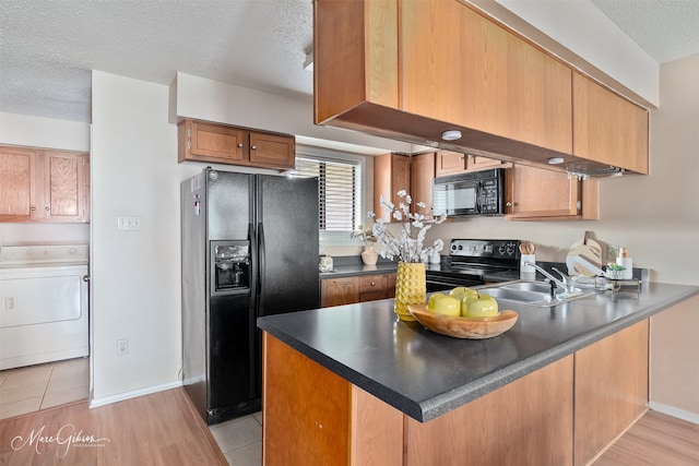 3636 Greenacres Place Dr Unit 33, Bossier City, LA 71111 - kitchen featuring washer / dryer, black appliances, a sink, a peninsula, and a textured ceiling