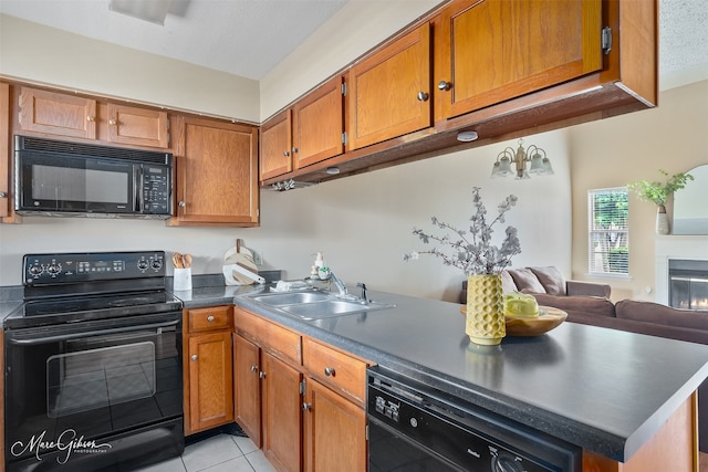 3636 Greenacres Place Dr Unit 33, Bossier City, LA 71111 - kitchen featuring black appliances, a sink, brown cabinetry, light tile patterned flooring, and dark countertops