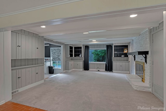 unfurnished living room with beam ceiling, a fireplace, and recessed lighting