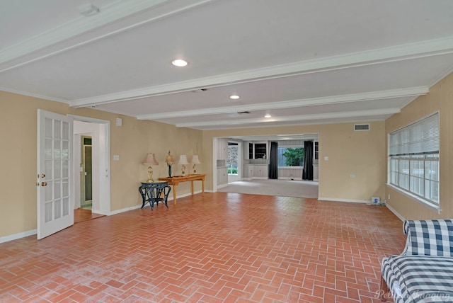 unfurnished living room with brick patterned flooring, baseboards, beam ceiling, crown molding, and french doors