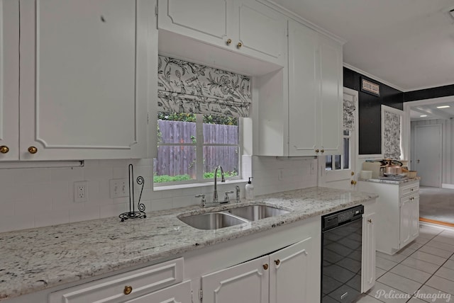 kitchen featuring a sink, dishwasher, white cabinetry, decorative backsplash, and light tile patterned flooring