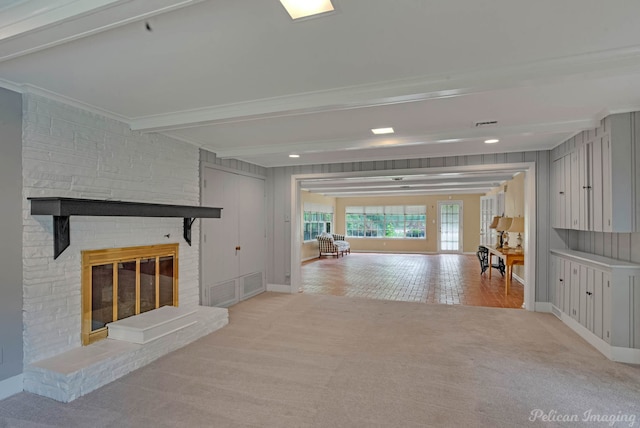 living area with light carpet, a large fireplace, baseboards, ornamental molding, and beam ceiling