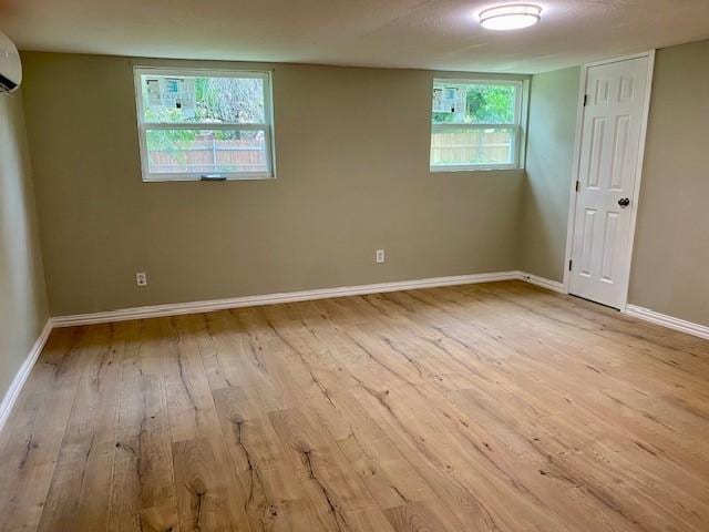 4916 Tracy Dr, Haltom City, TX 76117 - unfurnished bedroom with hardwood / wood-style flooring, baseboards, and a wall mounted AC
