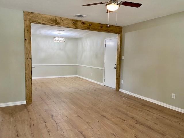 4916 Tracy Dr, Haltom City, TX 76117 - spare room featuring a ceiling fan, wood finished floors, baseboards, and a chandelier