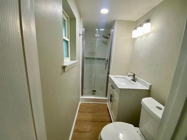 4916 Tracy Dr, Haltom City, TX 76117 - full bathroom with toilet, a stall shower, wood finished floors, vanity, and baseboards
