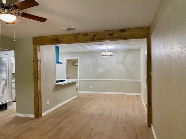 4916 Tracy Dr, Haltom City, TX 76117 - empty room with wood finished floors, a ceiling fan, baseboards, and a chandelier