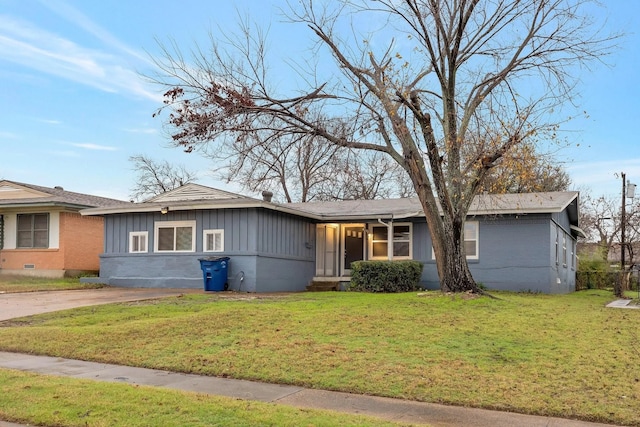 4208 Huckleberry Cir, Dallas, TX 75216 - view of front of home featuring a front yard, board and batten siding, and brick siding