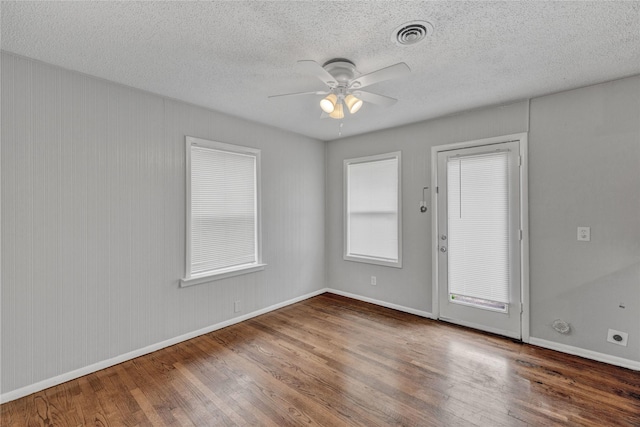 4208 Huckleberry Cir, Dallas, TX 75216 - unfurnished room with wood finished floors, ceiling fan, baseboards, and a textured ceiling