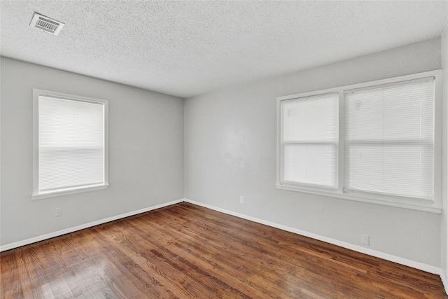 4208 Huckleberry Cir, Dallas, TX 75216 - spare room with a textured ceiling, wood finished floors, and baseboards