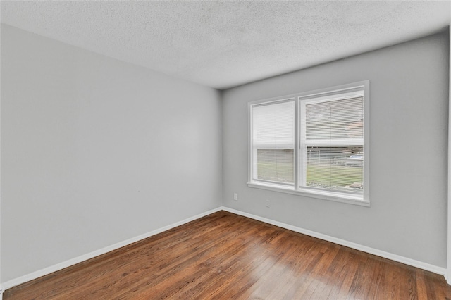 4208 Huckleberry Cir, Dallas, TX 75216 - spare room featuring wood finished floors, baseboards, and a textured ceiling