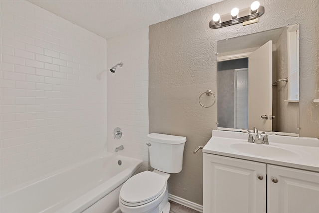 4208 Huckleberry Cir, Dallas, TX 75216 - full bathroom with a textured wall, toilet, vanity, tub / shower combination, and baseboards