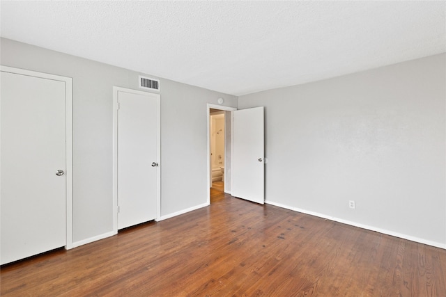 4208 Huckleberry Cir, Dallas, TX 75216 - unfurnished bedroom featuring wood finished floors and baseboards