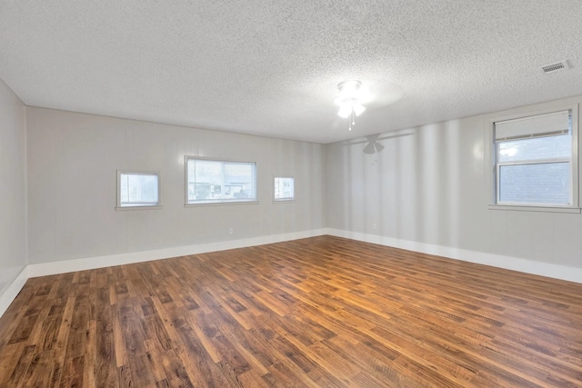 4208 Huckleberry Cir, Dallas, TX 75216 - empty room with wood finished floors, a textured ceiling, and a ceiling fan