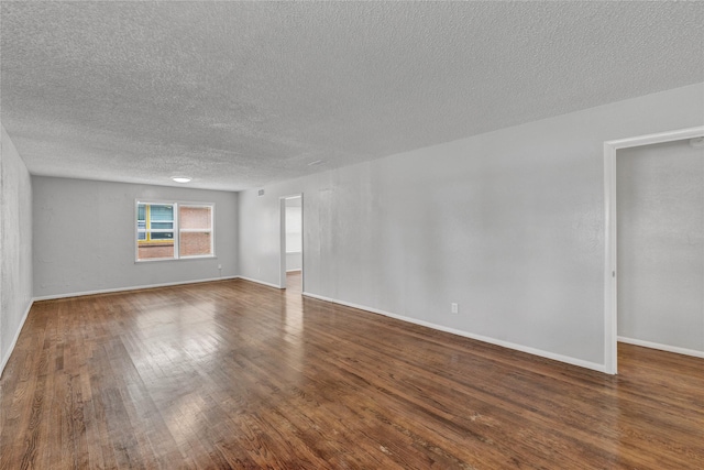 4208 Huckleberry Cir, Dallas, TX 75216 - empty room with a textured ceiling, dark wood-style flooring, and baseboards