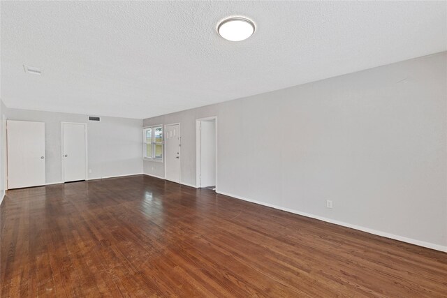 4208 Huckleberry Cir, Dallas, TX 75216 - spare room with wood finished floors, baseboards, and a textured ceiling