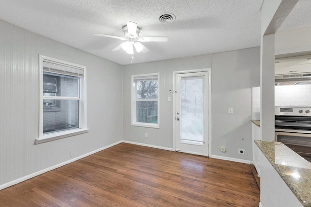 4208 Huckleberry Cir, Dallas, TX 75216 - unfurnished dining area featuring wood finished floors, a ceiling fan, baseboards, and a textured ceiling