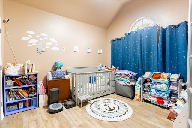 6500 Fannin Farm Way, Arlington, TX 76001 - bedroom featuring vaulted ceiling, wood finished floors, and a nursery area