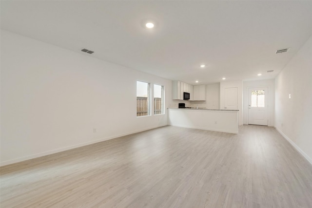 4213 Brindley Rd, Little Elm, TX 75068 - unfurnished living room with recessed lighting, light wood-style flooring, and baseboards