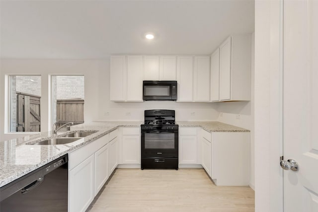 4213 Brindley Rd, Little Elm, TX 75068 - kitchen featuring black appliances, a sink, white cabinets, light wood finished floors, and recessed lighting