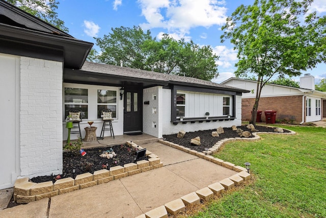 1807 W Belden St, Sherman, TX 75092 - doorway to property with brick siding, a yard, and roof with shingles