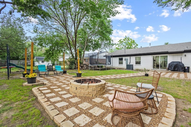 1807 W Belden St, Sherman, TX 75092 - view of patio with a trampoline, an outdoor fire pit, central AC, and area for grilling