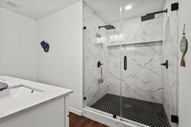 1807 W Belden St, Sherman, TX 75092 - full bathroom featuring wood finished floors, a marble finish shower, vanity, and baseboards