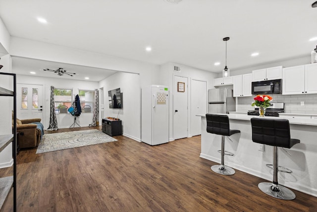 1807 W Belden St, Sherman, TX 75092 - kitchen featuring black microwave, freestanding refrigerator, range, light countertops, and open floor plan